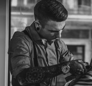 Barber does men`s haircut