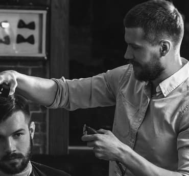 Barber does men`s haircut